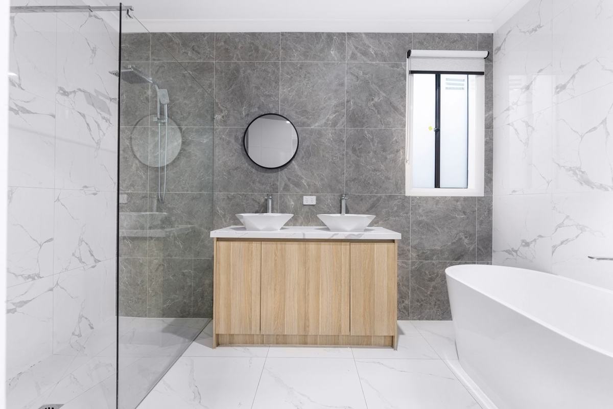 A newly renovated bathroom with walk-in shower and freestanding bath